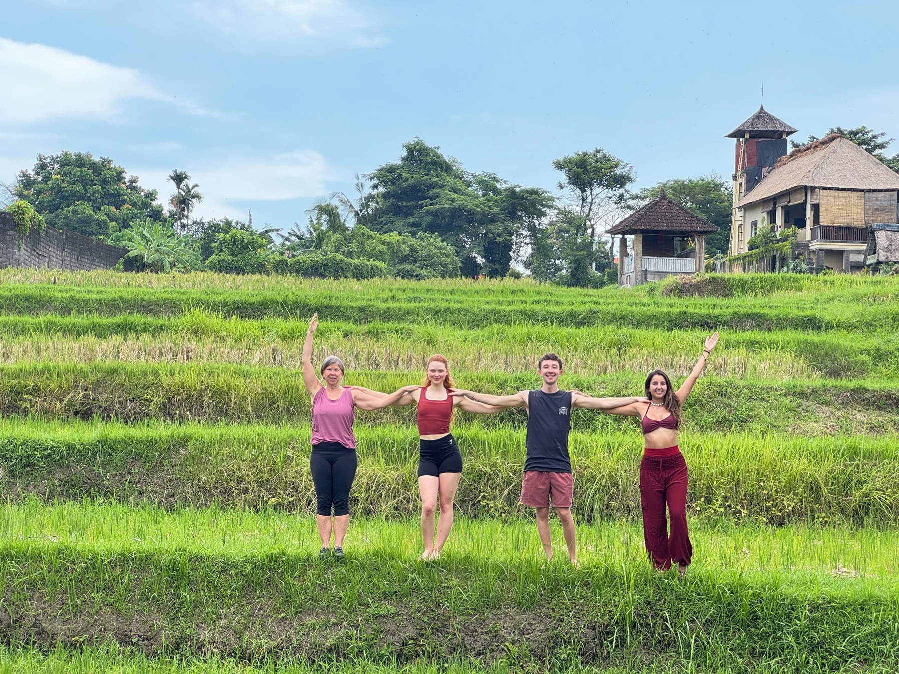 Four students practising together among green rice terraces