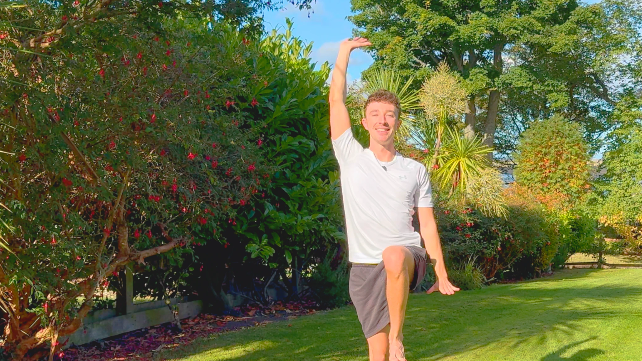 Max reaching upwards during Qigong in a sunny garden
