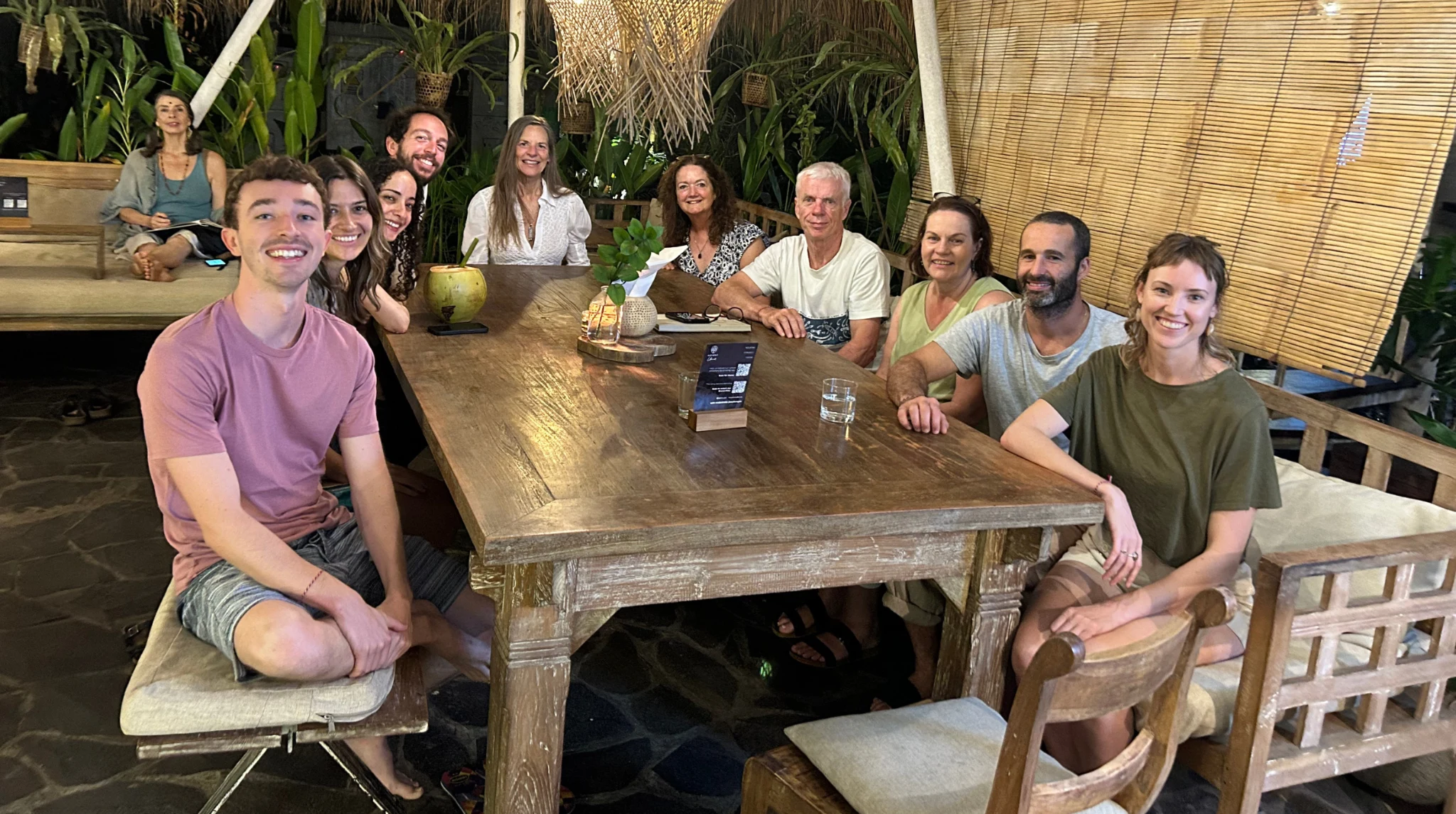 Friends sharing a meal around a wooden table