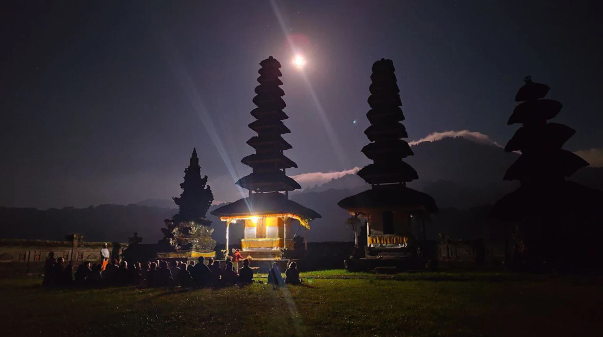 Balinese temple towers beneath a glowing evening sky